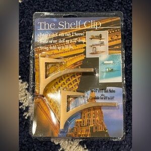 The Shelf Clip for 3/8"-1/2" mounts shelf up to 12" deep. Brushed Brass / Gold